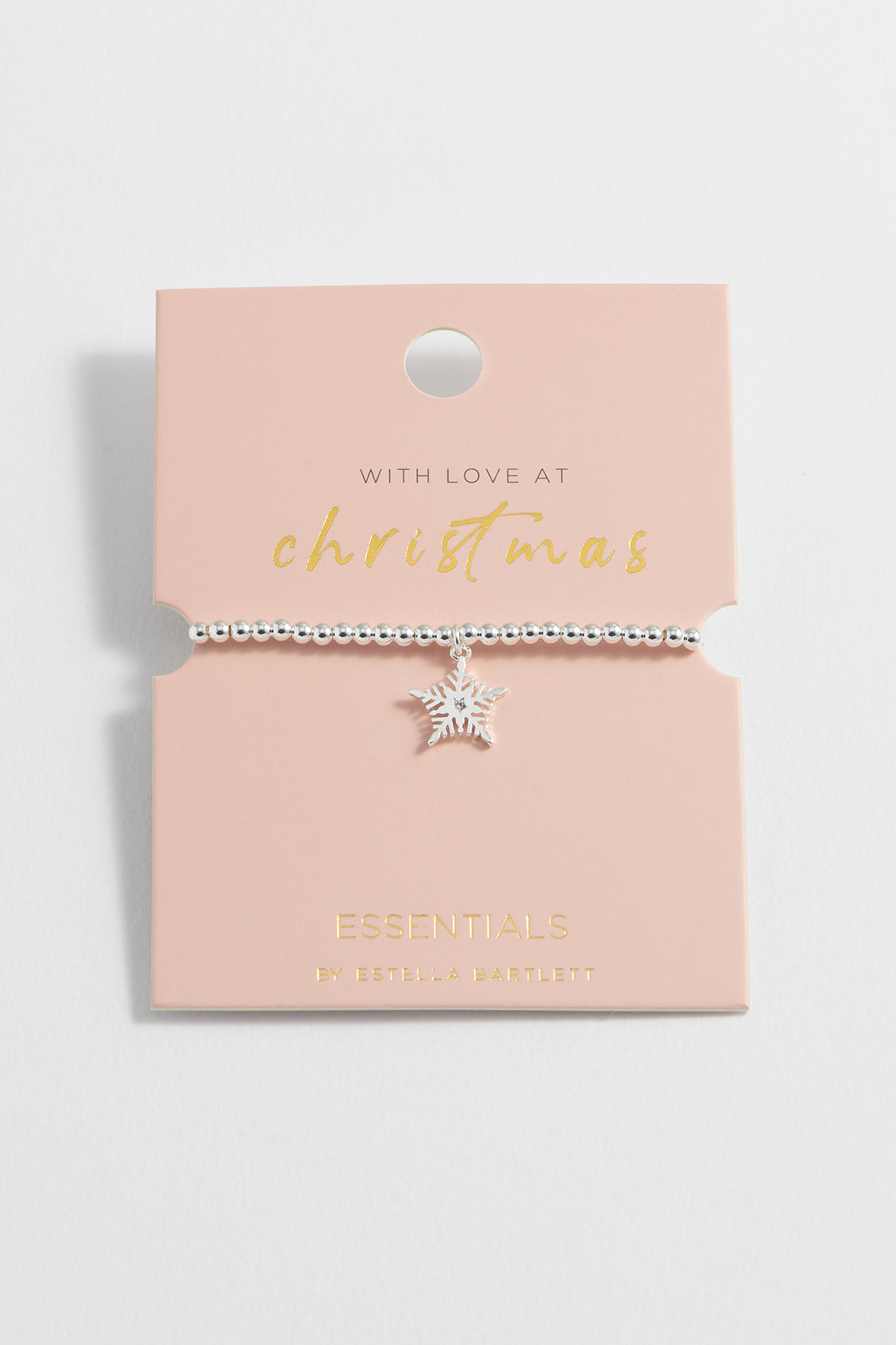 Star-shaped necklace on a pink card with gold text
