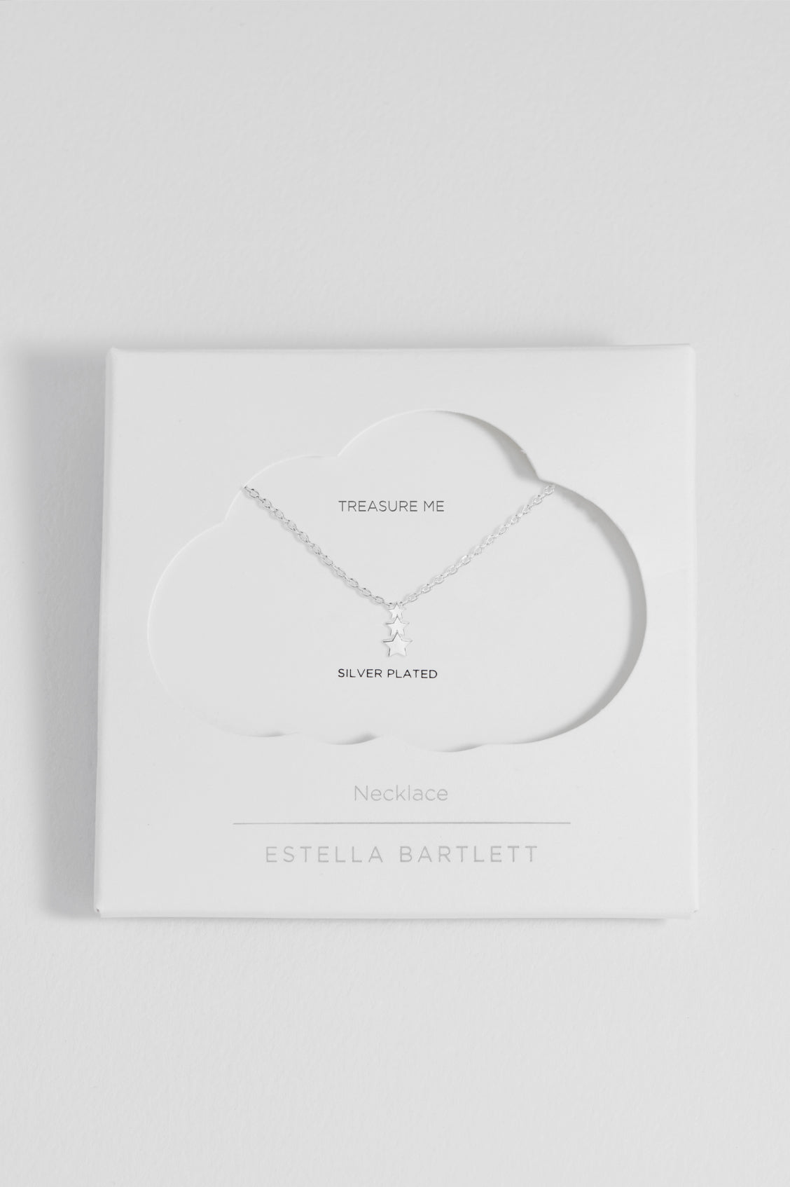 Silver necklace in packaging with 'Estella Bartlett' branding on a white background