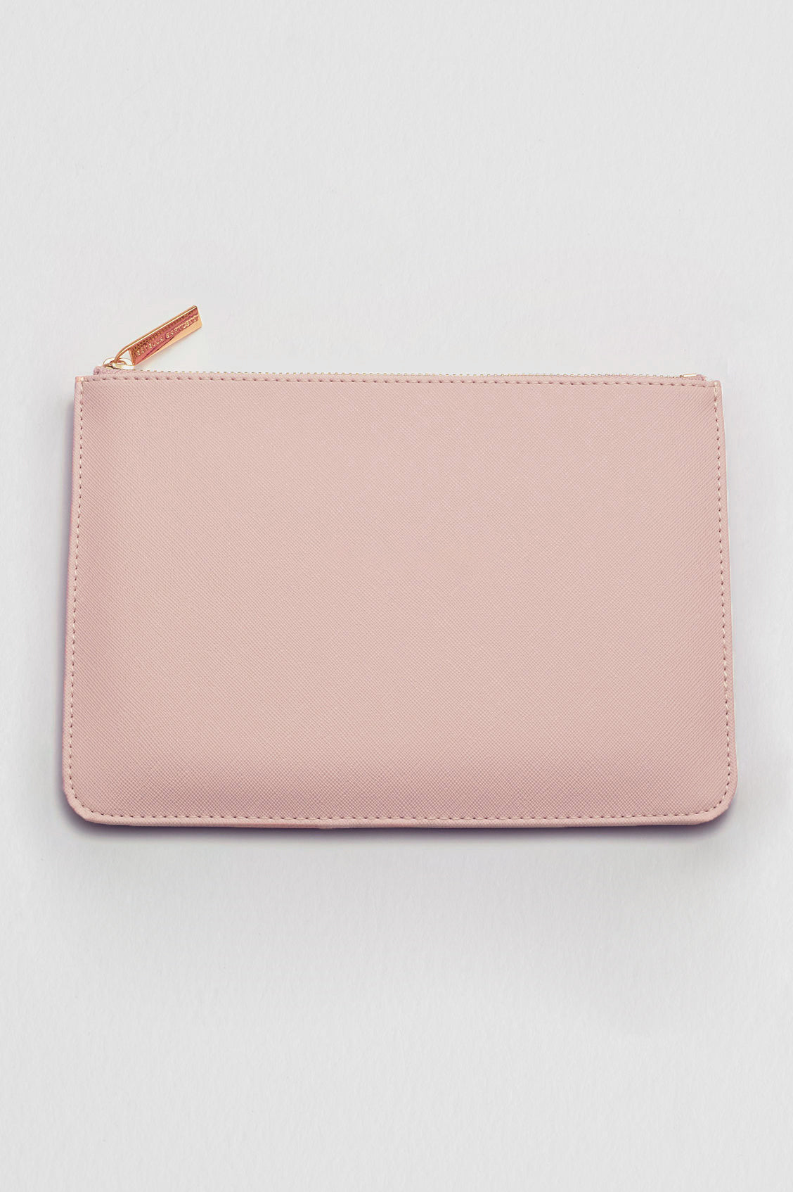 Pink pouch with a gold zipper on a light gray background