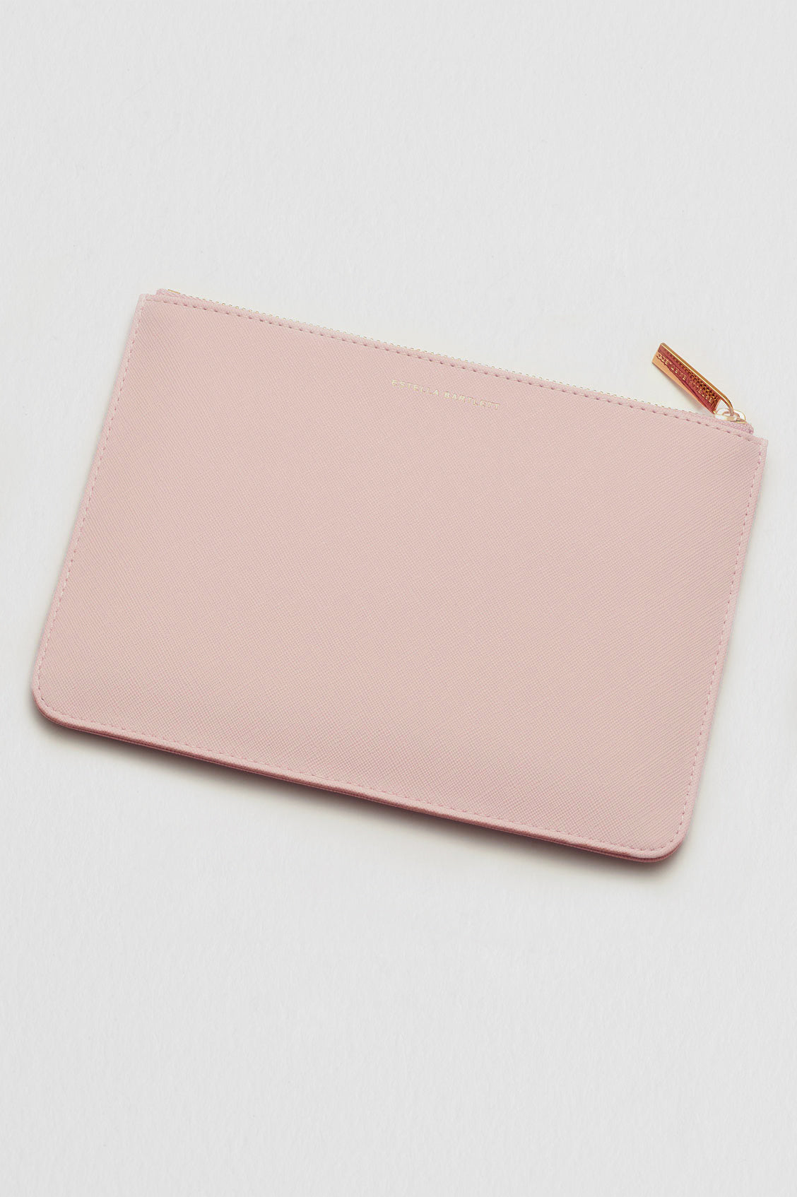 Pink pouch with a gold zipper on a light gray background