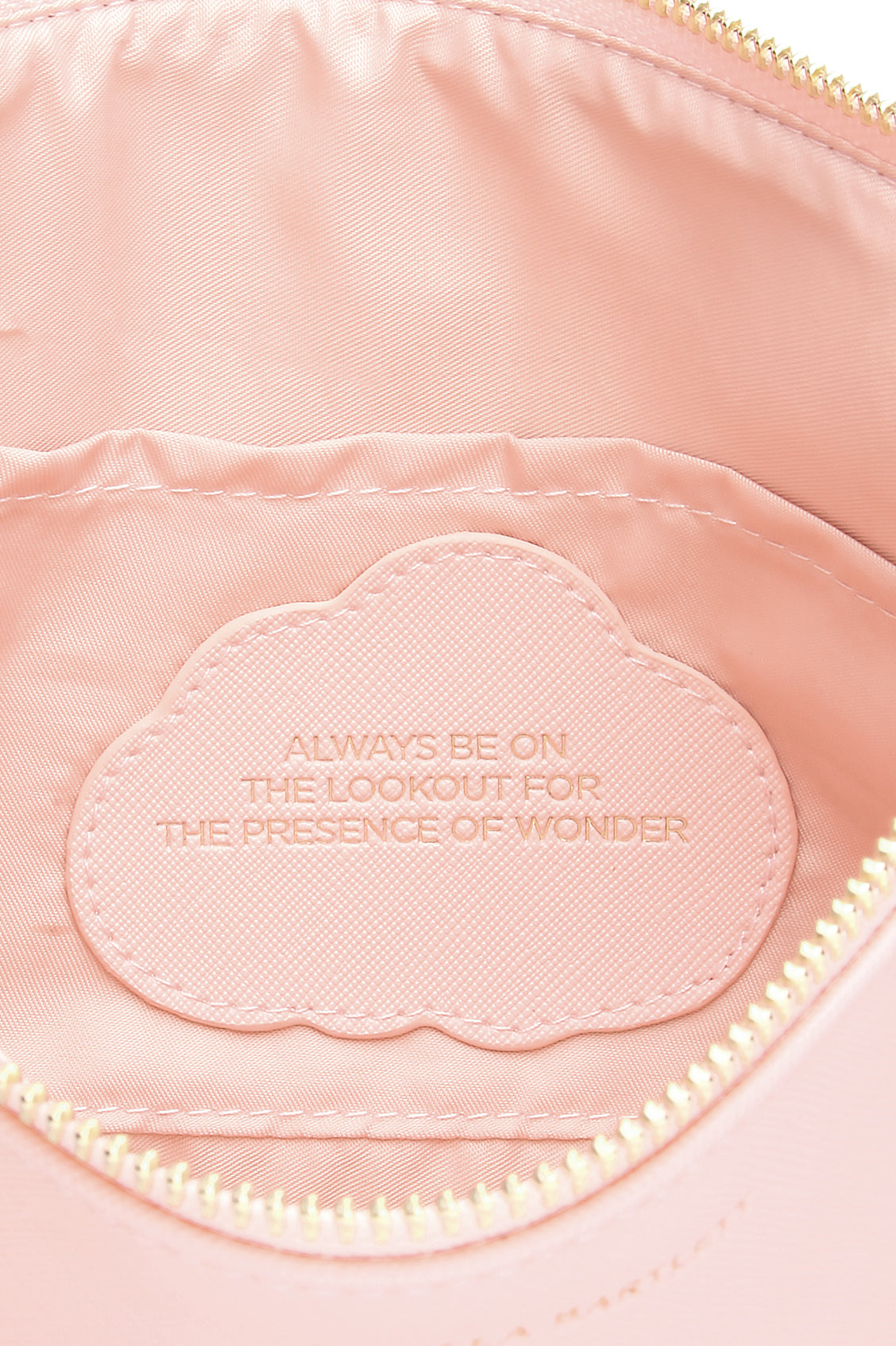 Pink bag with embroidered text 'Always be on the lookout for the presence of wonder'.