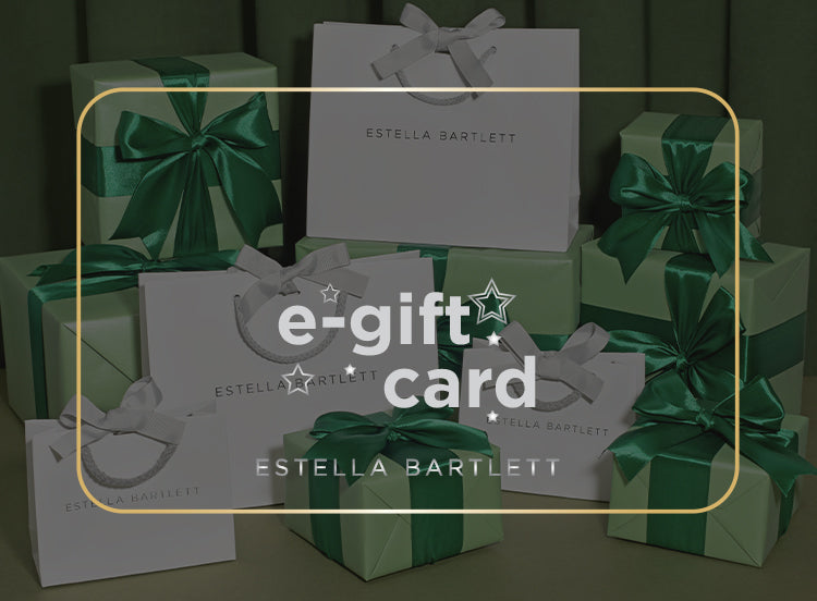 Green gift boxes with ribbons and Estella Bartlett branding, featuring an e-gift card overlay.